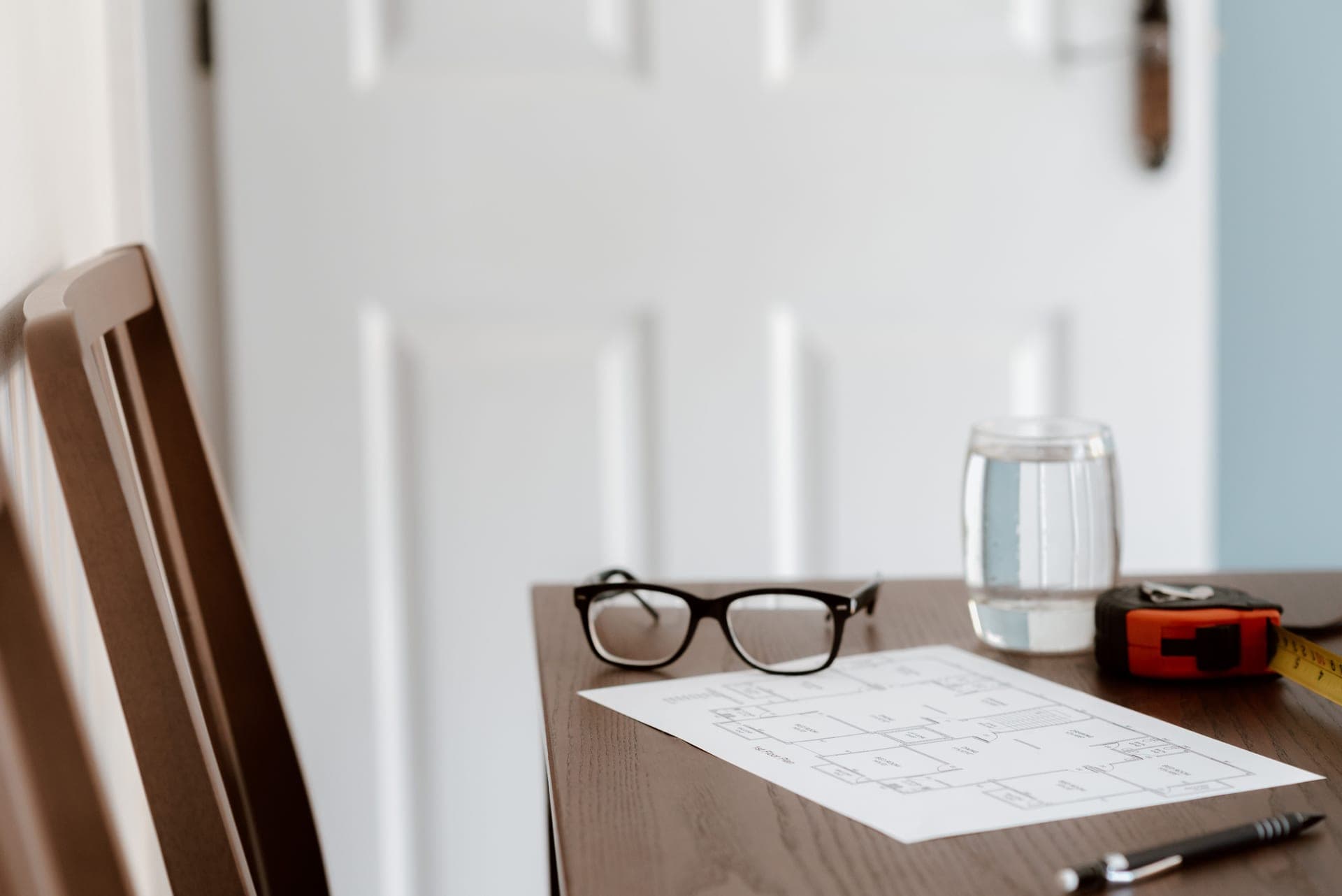 Printed specification documents and a measuring tool on a desk